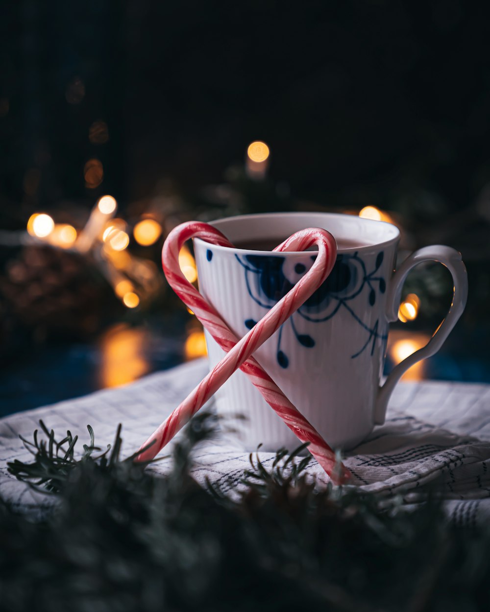 a cup with a candy cane in it