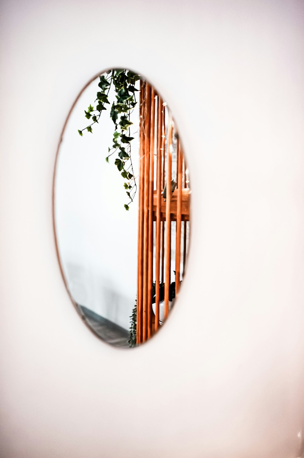 a round mirror reflecting a wooden structure