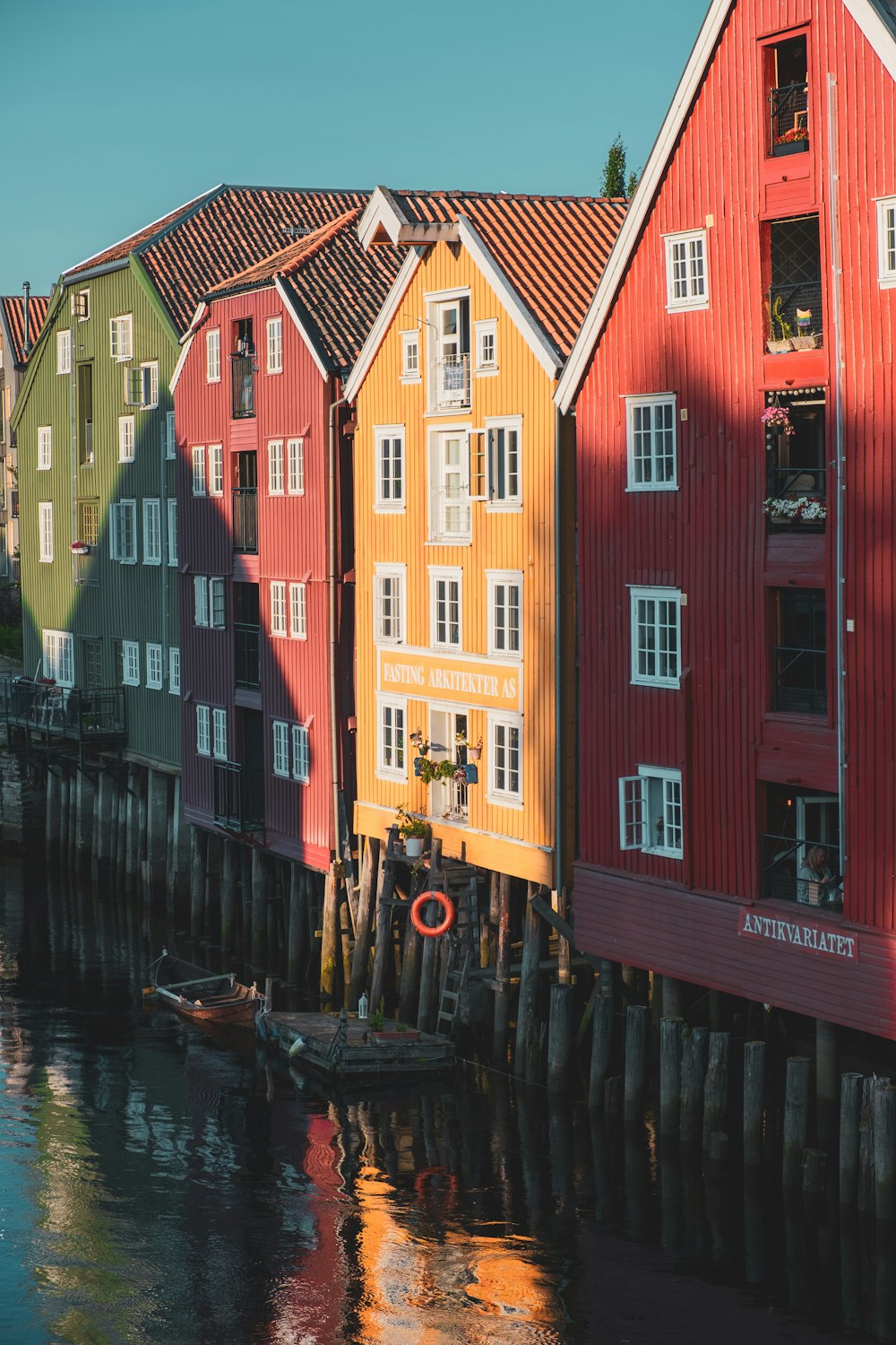 a row of houses sitting next to a body of water