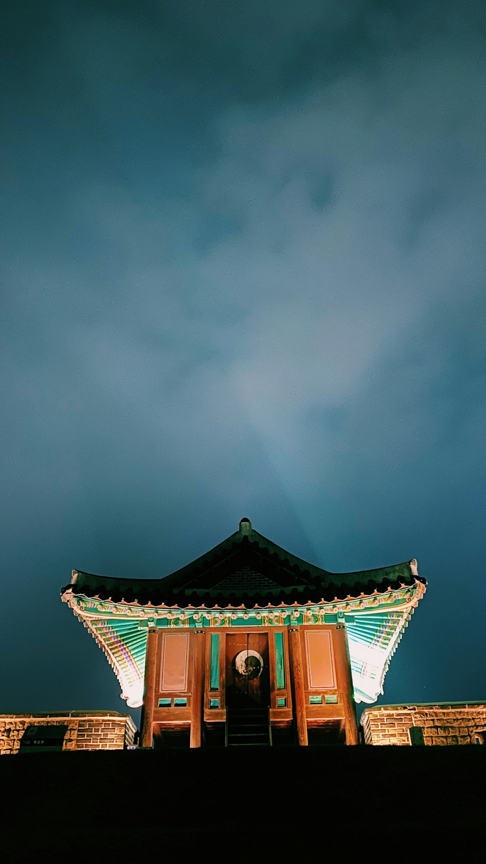 a tall building with a sky in the background