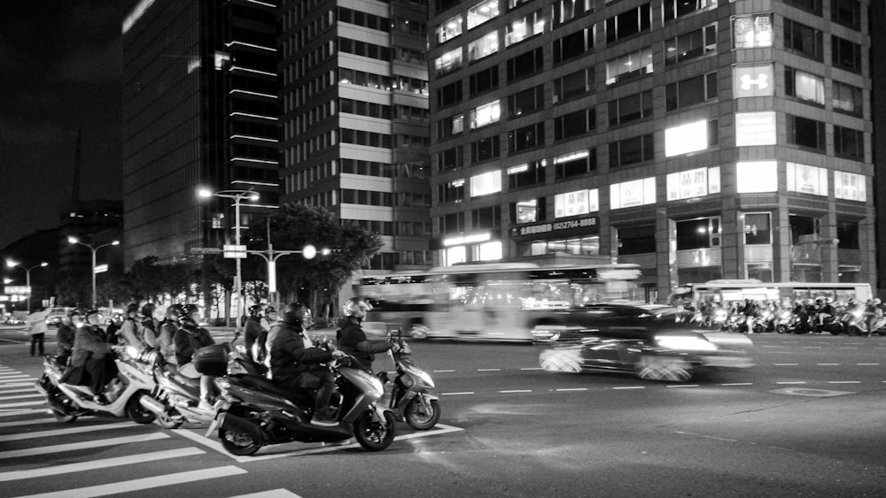 a group of people riding motorcycles down a street