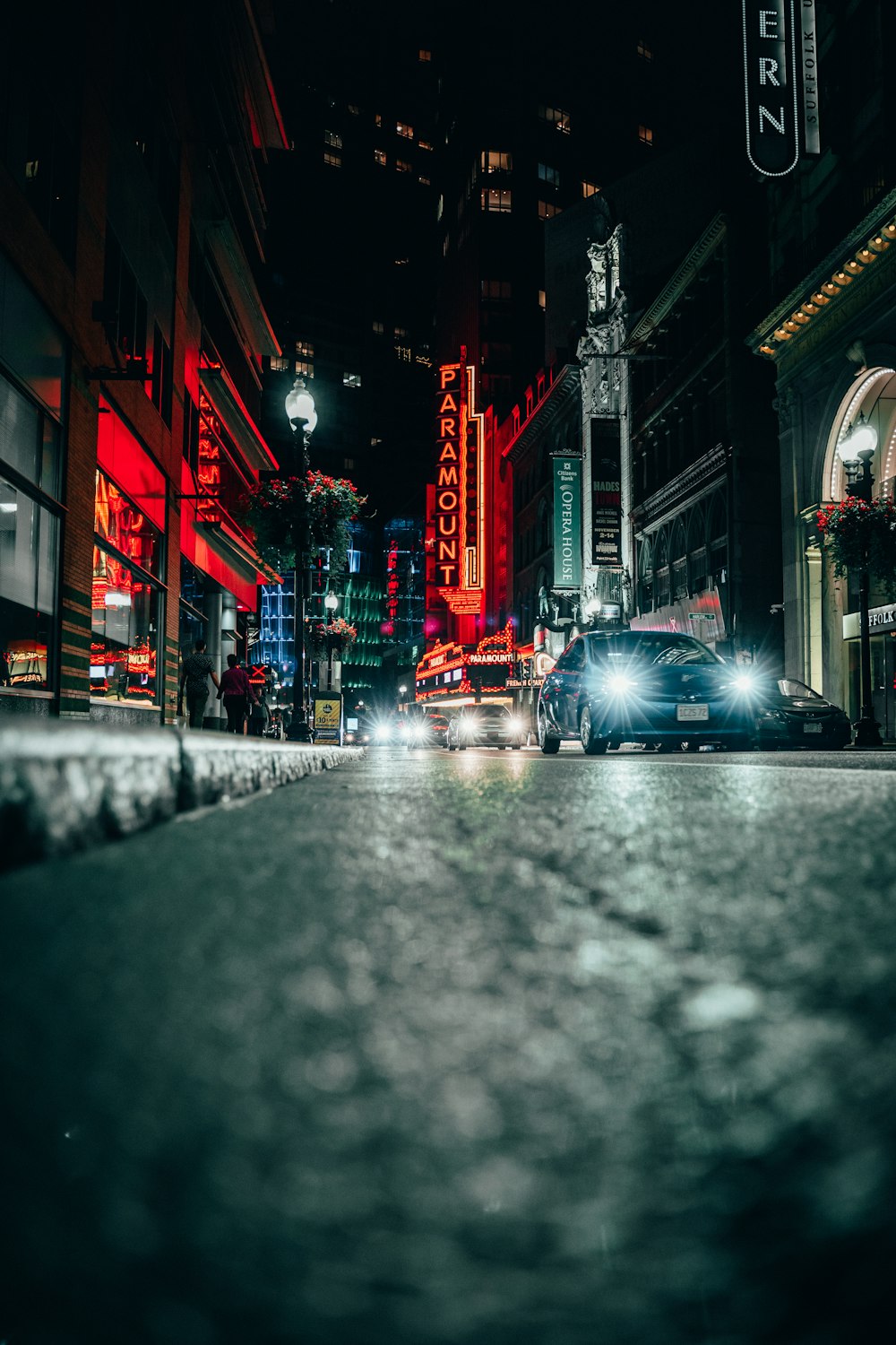 a car driving down a city street at night