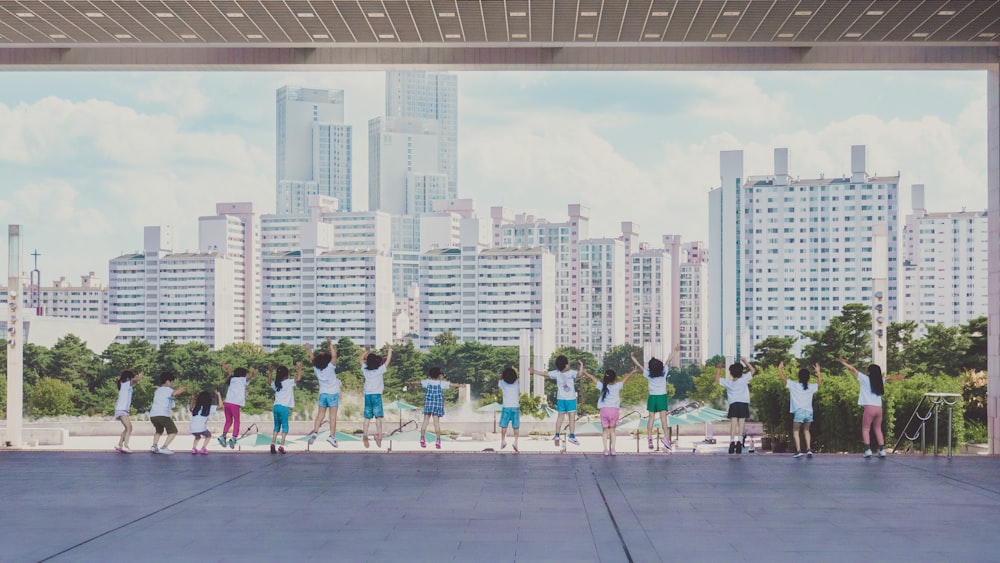 a group of people standing in front of a city skyline