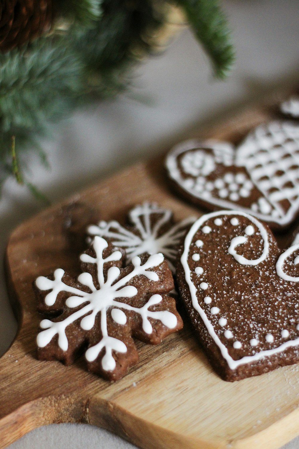 a wooden cutting board topped with cookies on top of a table