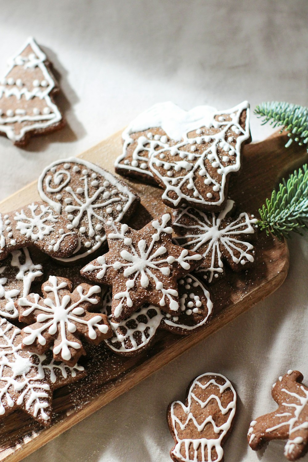 a wooden cutting board topped with cut out cookies