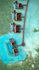 an aerial view of a pier and a body of water