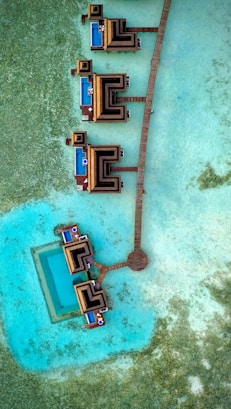 an aerial view of a pier and a body of water
