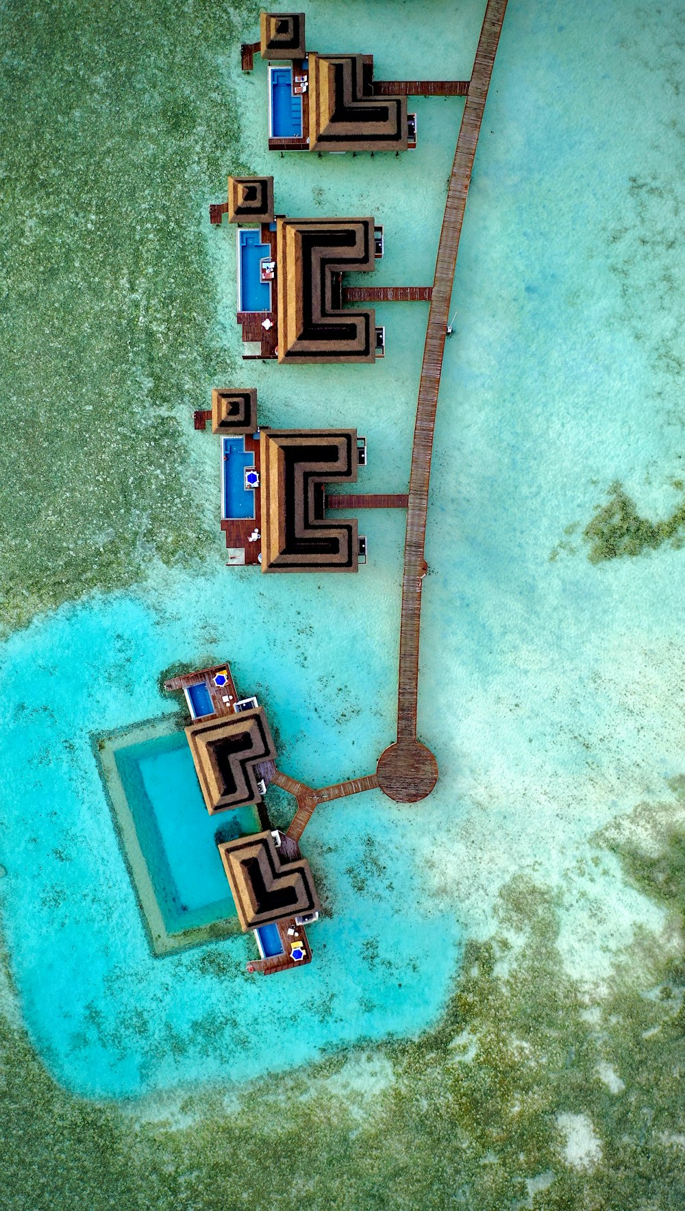 an aerial view of a pier and a body of water