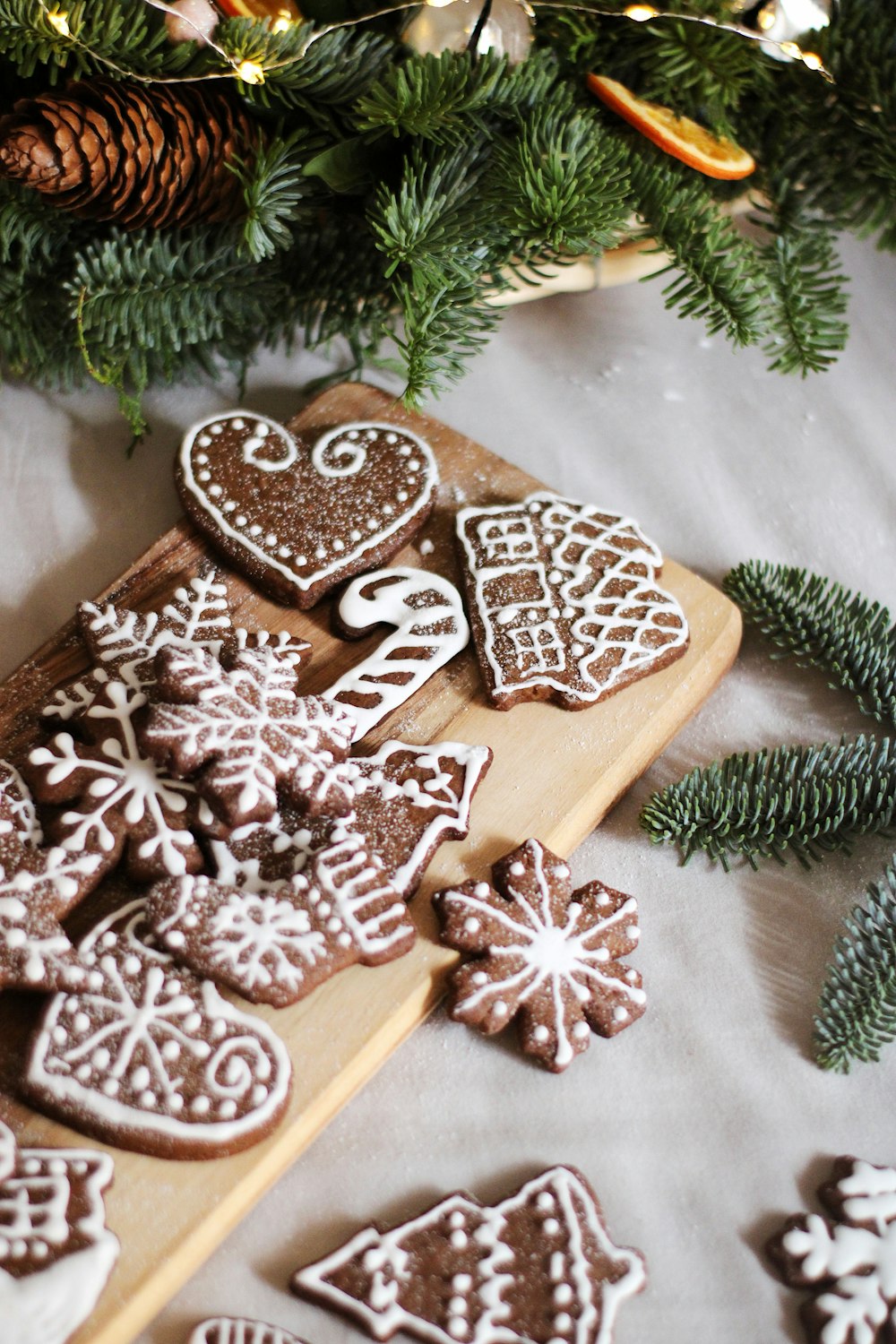 a wooden cutting board topped with lots of cookies