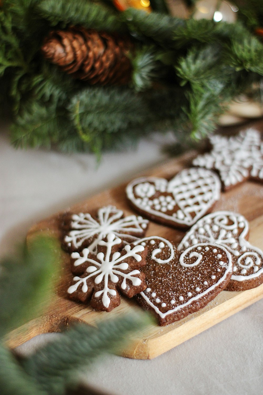 a wooden cutting board topped with cookies on top of a table