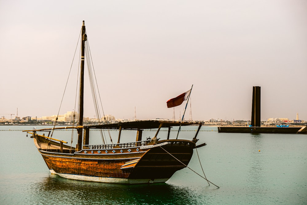 a sailboat in the water with a flag on it