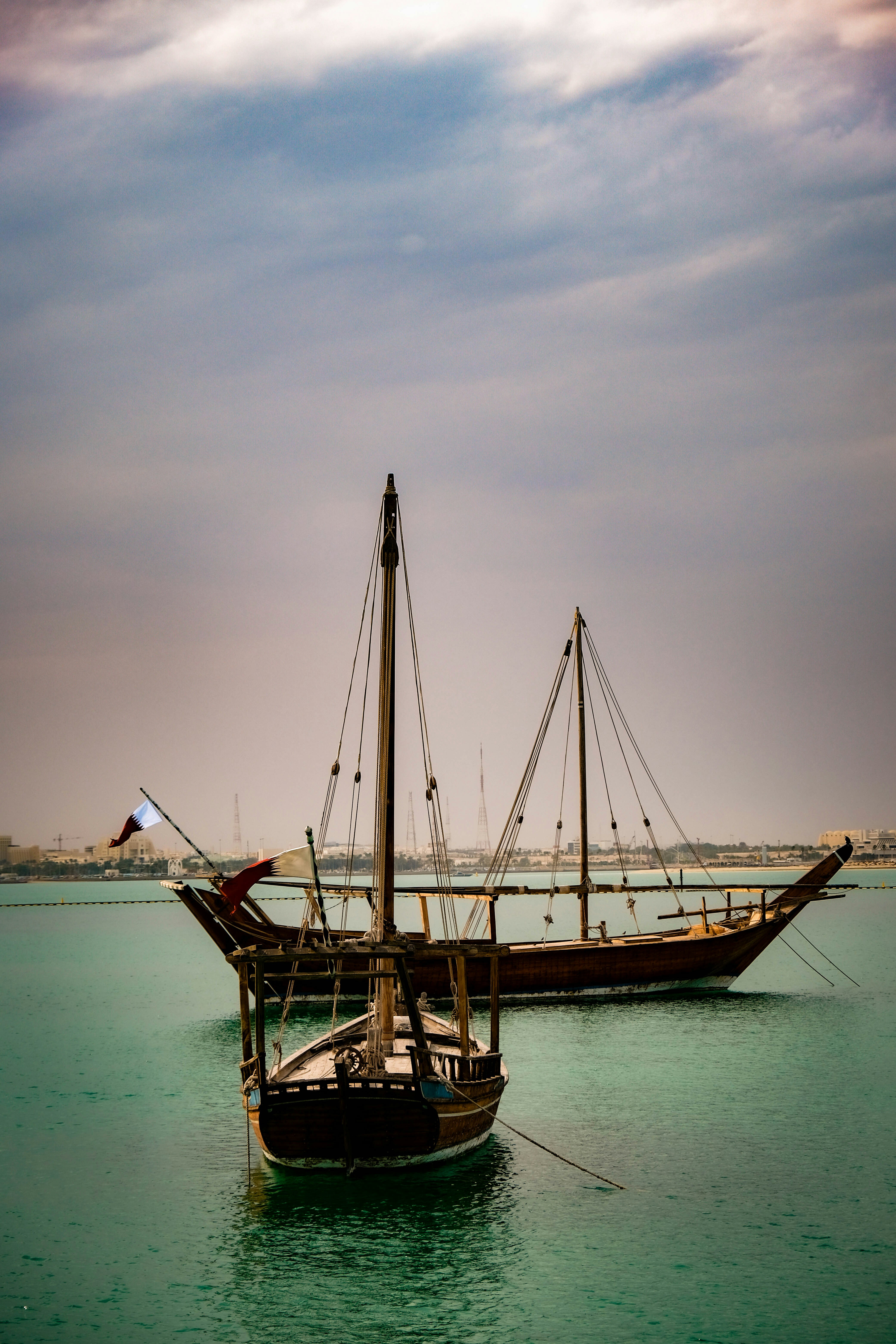 a couple of boats floating on top of a body of water