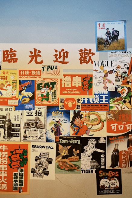 A collage of vintage and retro posters featuring various themes. The posters include advertisements with bold, colorful graphics and characters from popular media. Some posters have Chinese text, while others depict recognizable characters from cartoons and movies. The colors are vibrant, with a mix of warm and cool tones.