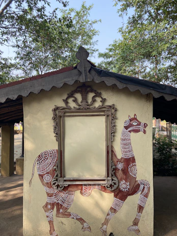 Traditional camel motifs carved into a wooden panel, reflecting desert culture artistry.