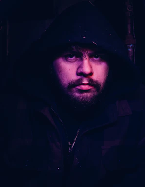 Close-up of a vintage-inspired hoodie with textured fabric under moody lighting.