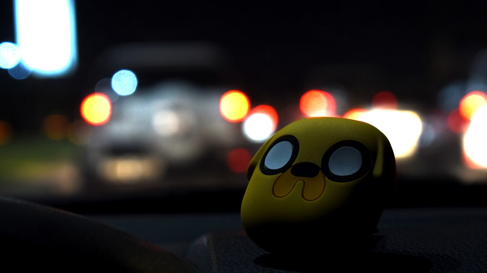 a close up of a toy on a car dashboard
