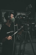 A professional security guard monitoring a surveillance camera in a control room.
