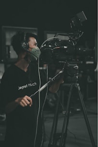 A professional security guard monitoring a surveillance camera in a control room.