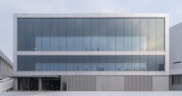 A modern two-story commercial building with large glass windows and a clean facade.