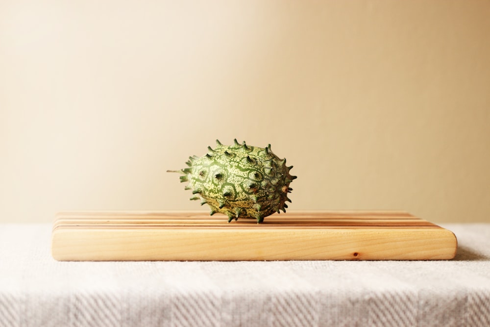 a pineapple sitting on top of a wooden cutting board