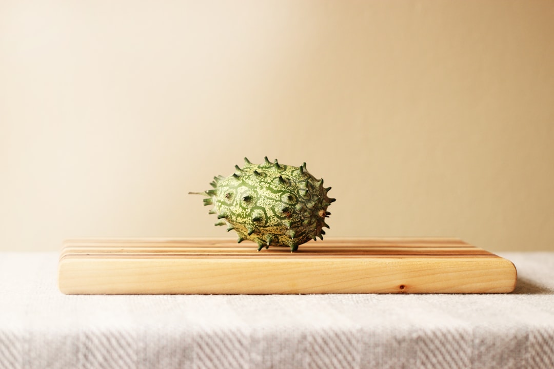 a pineapple sitting on top of a wooden cutting board,