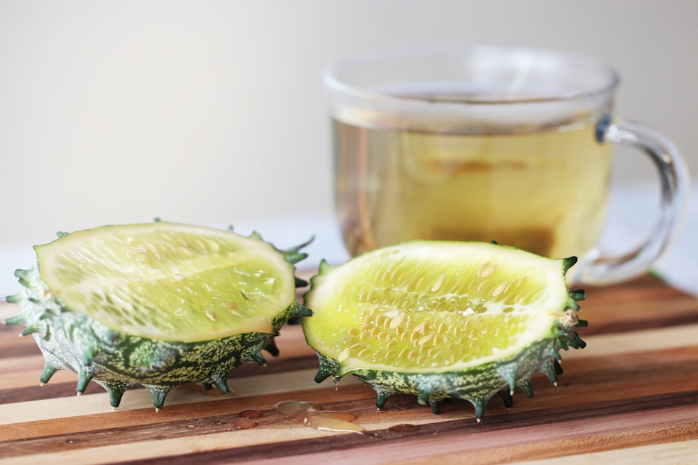 a couple of pieces of fruit sitting on top of a wooden cutting board