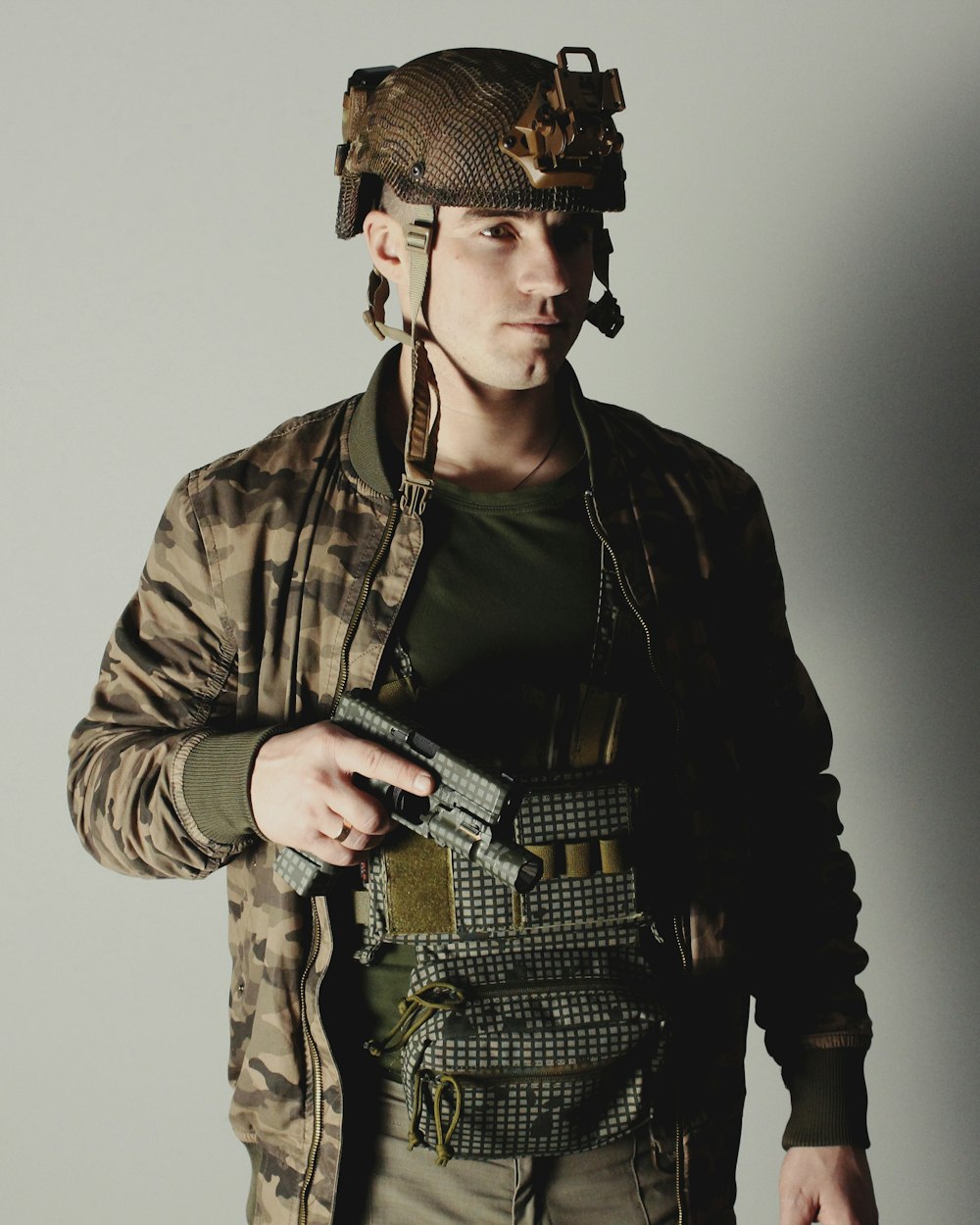 a man in a military uniform holding a gun