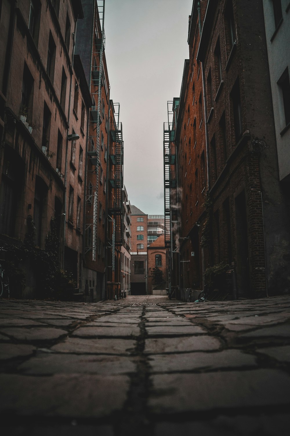 a narrow alley way between two buildings with scaffolding on them