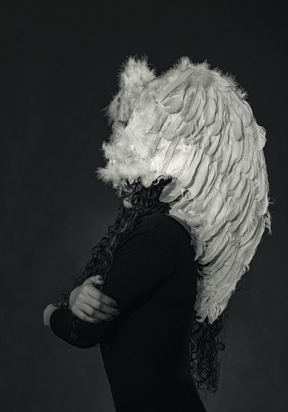 a woman with a white feathered hat on her head