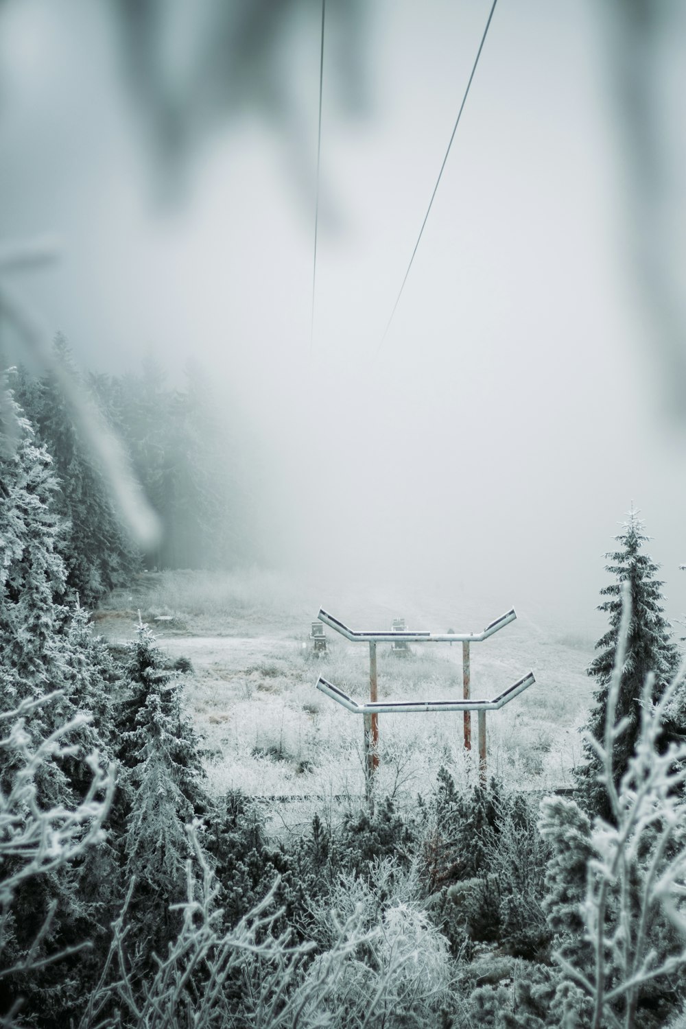 a ski lift in the middle of a snowy field