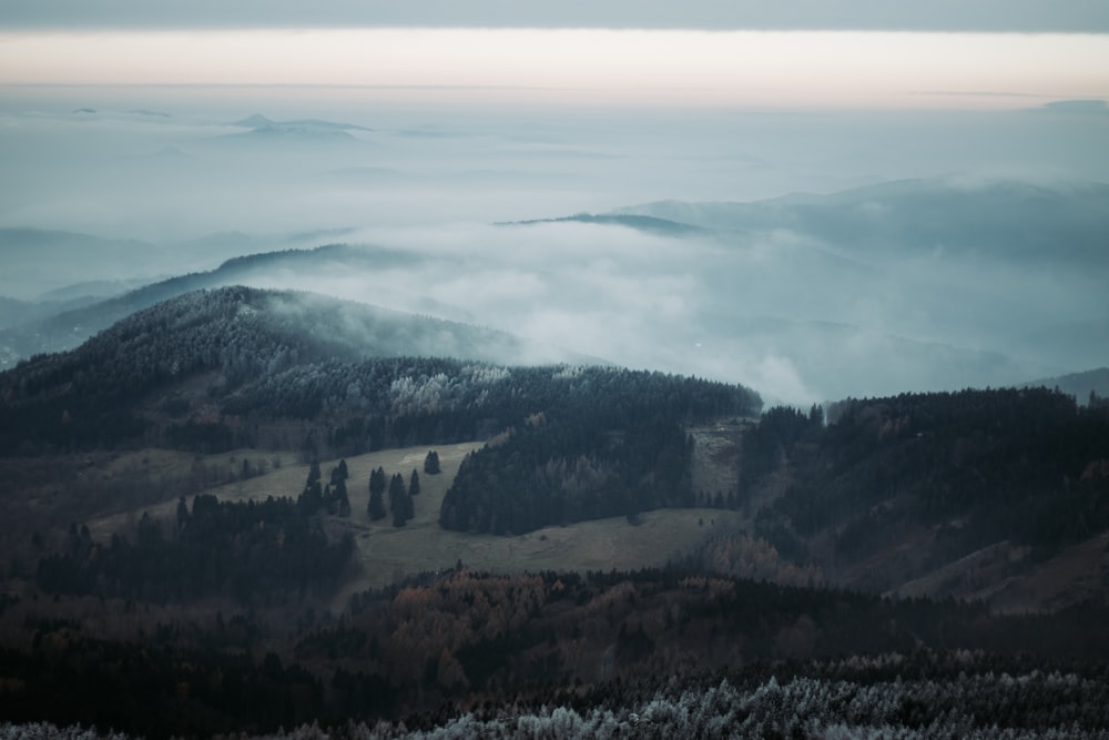 a view of a mountain range covered in fog
