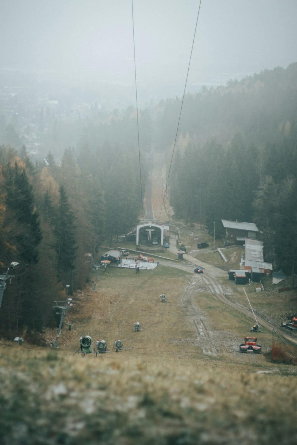 a ski lift going up a hill in the fog