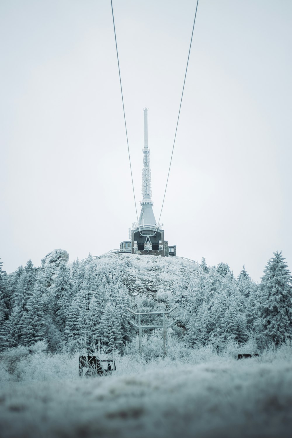 a ski lift going up a snowy mountain