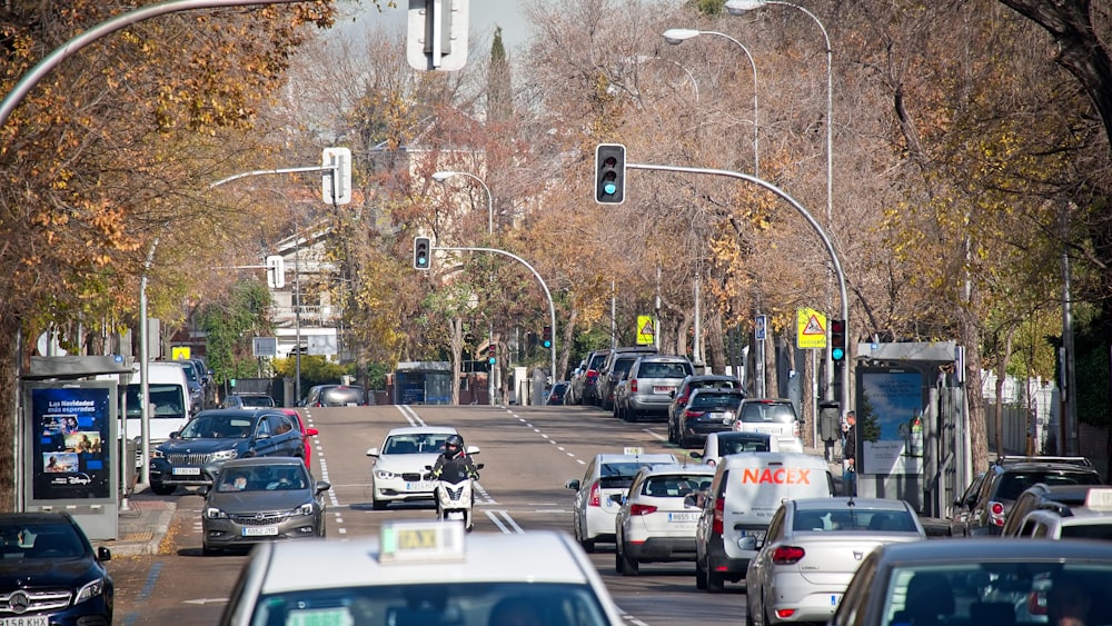 a street filled with lots of traffic next to trees