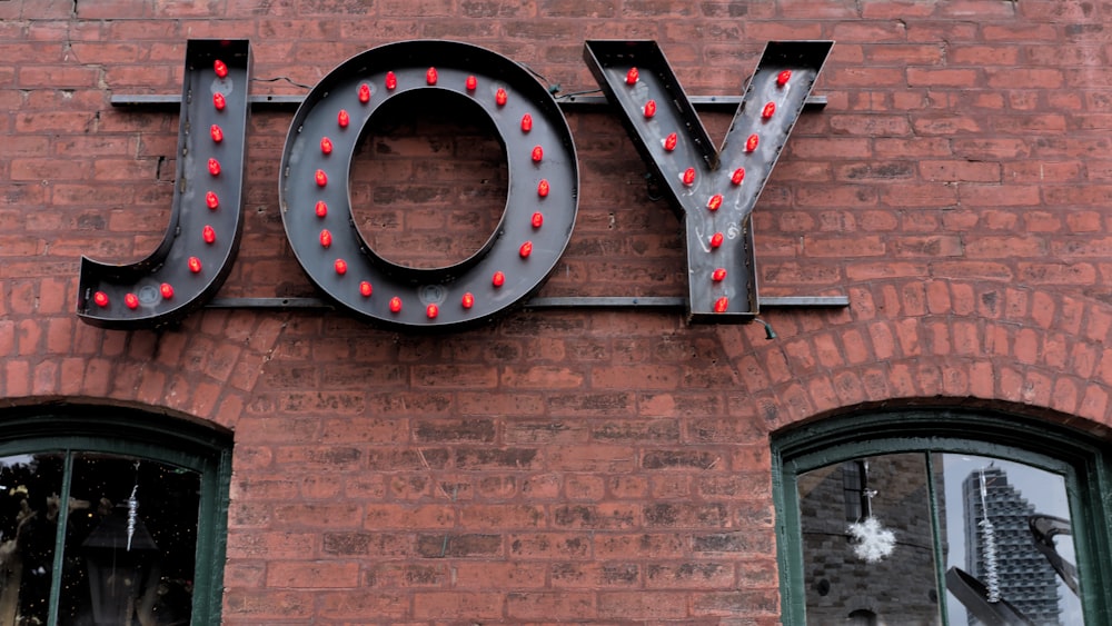 a sign that says joy on the side of a building