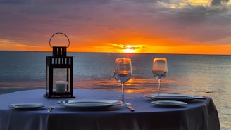 a couple of glasses of wine sitting on top of a table