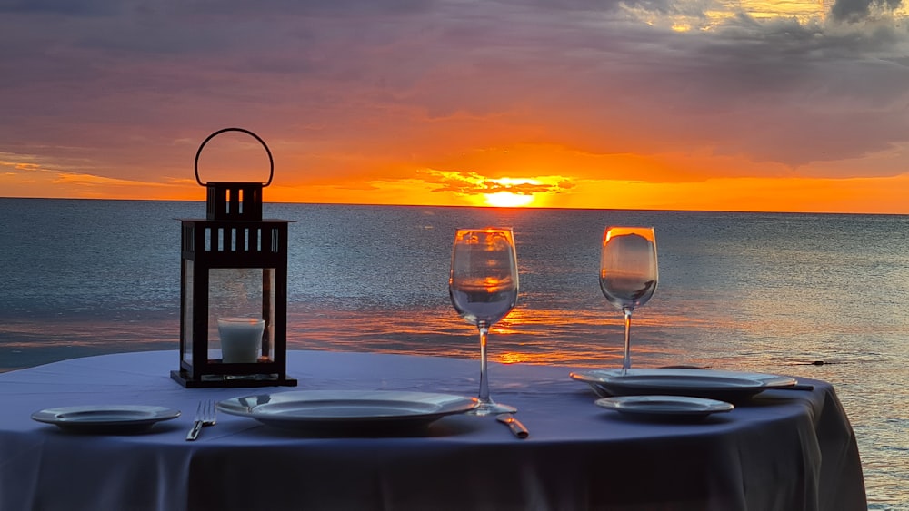 a couple of glasses of wine sitting on top of a table