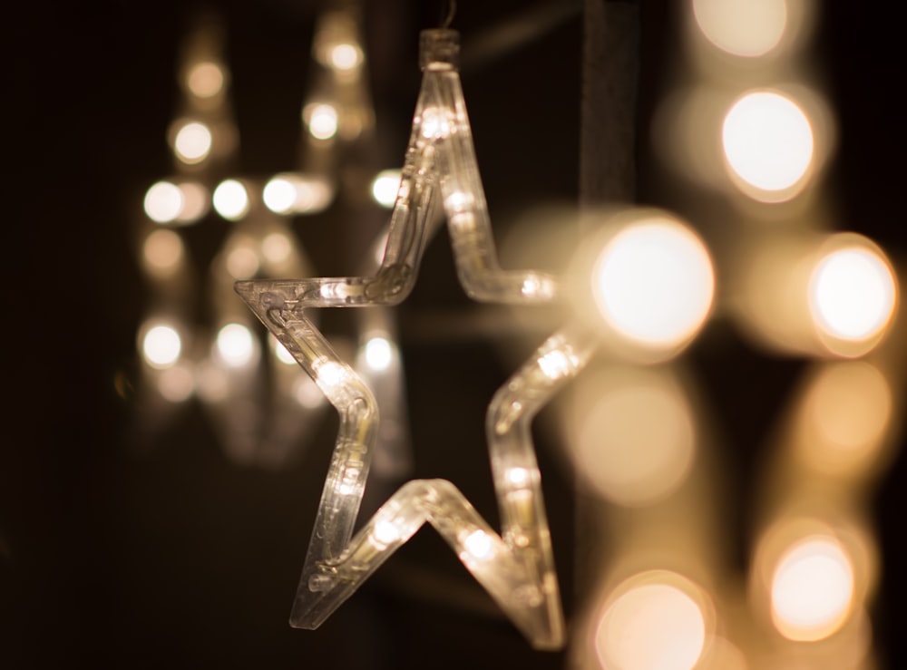 a lighted star hanging from a string of lights