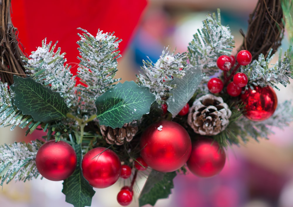 a vase filled with christmas decorations and pine cones