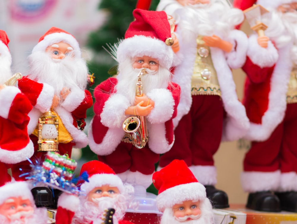 a group of santa clause figurines with instruments