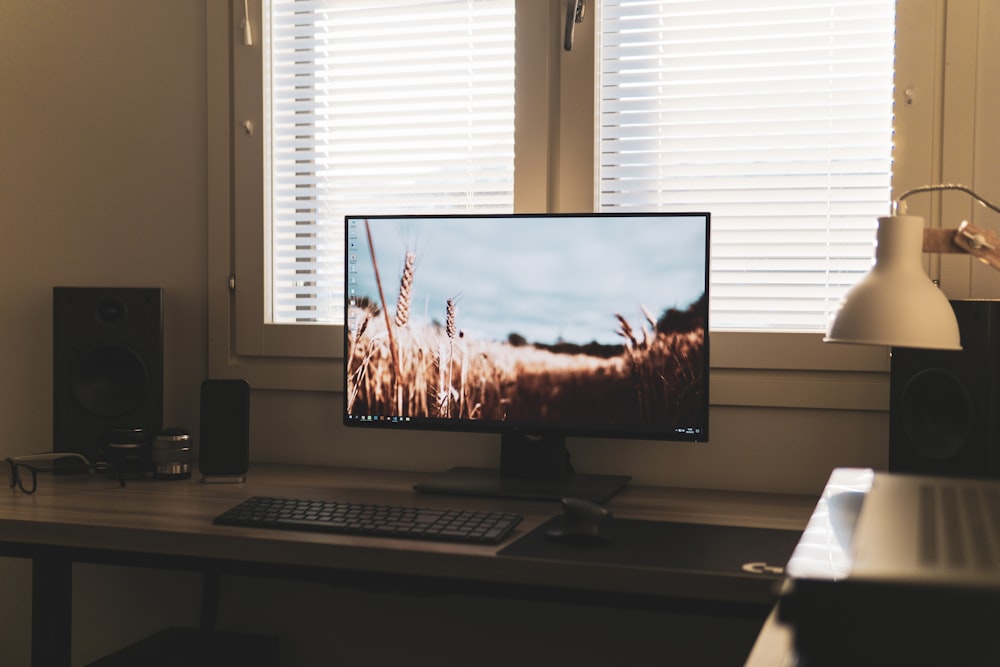 a computer monitor sitting on top of a wooden desk