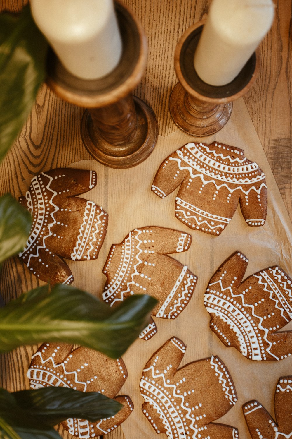 a wooden table topped with cookies and candles