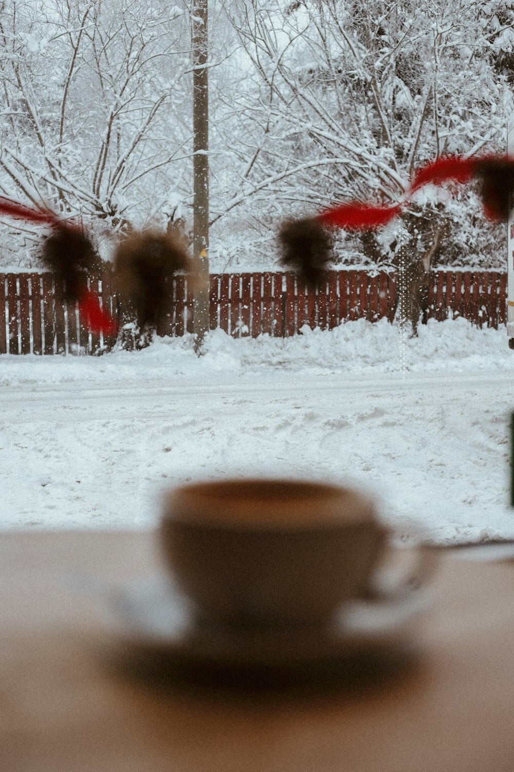 a cup of coffee sitting on top of a wooden table