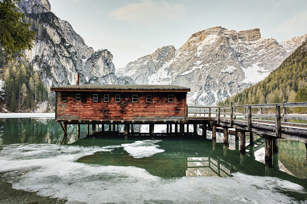 a wooden dock with a small cabin on top of it