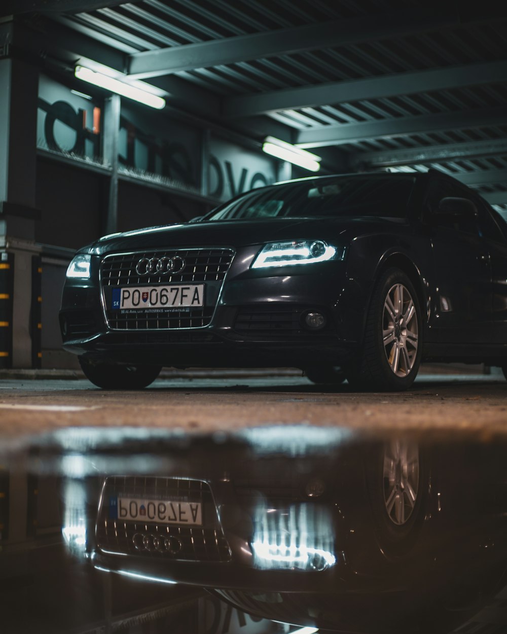 a black car parked in a parking garage