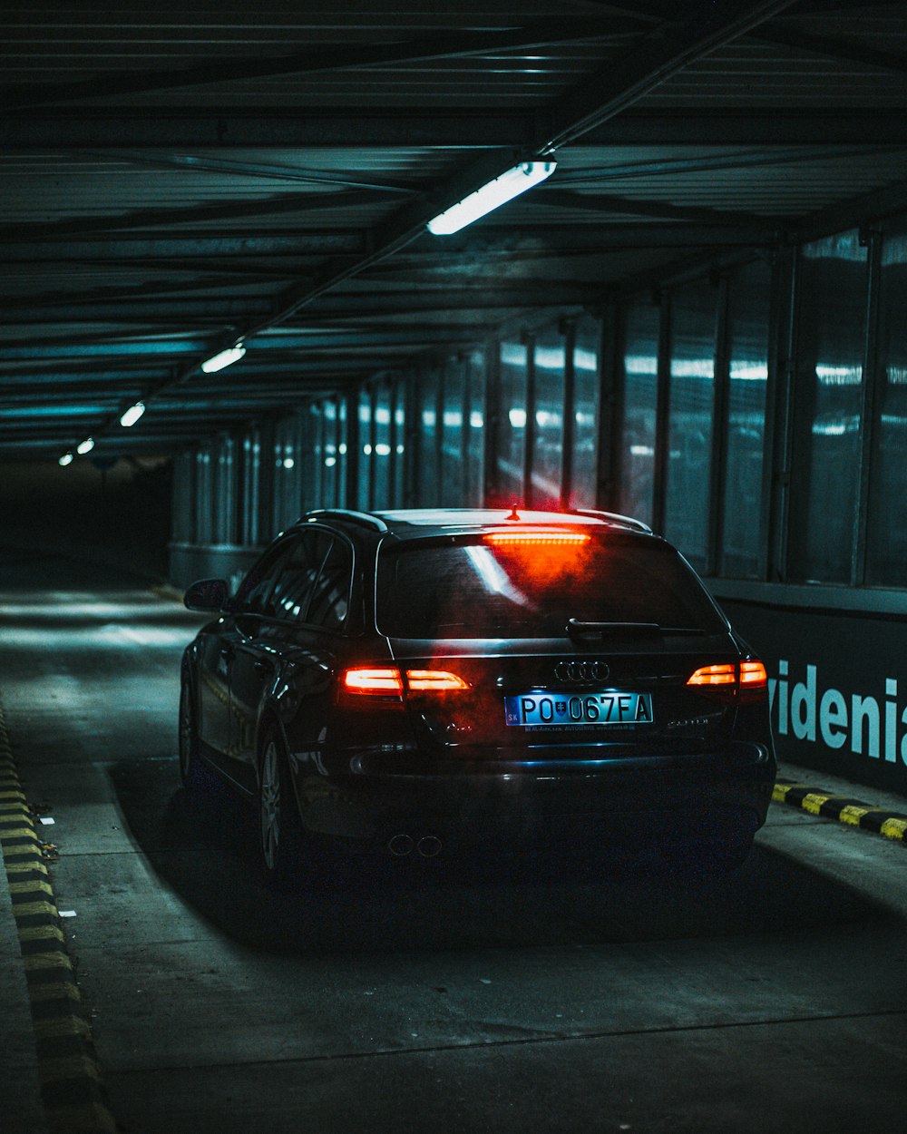 a black car parked in a parking garage