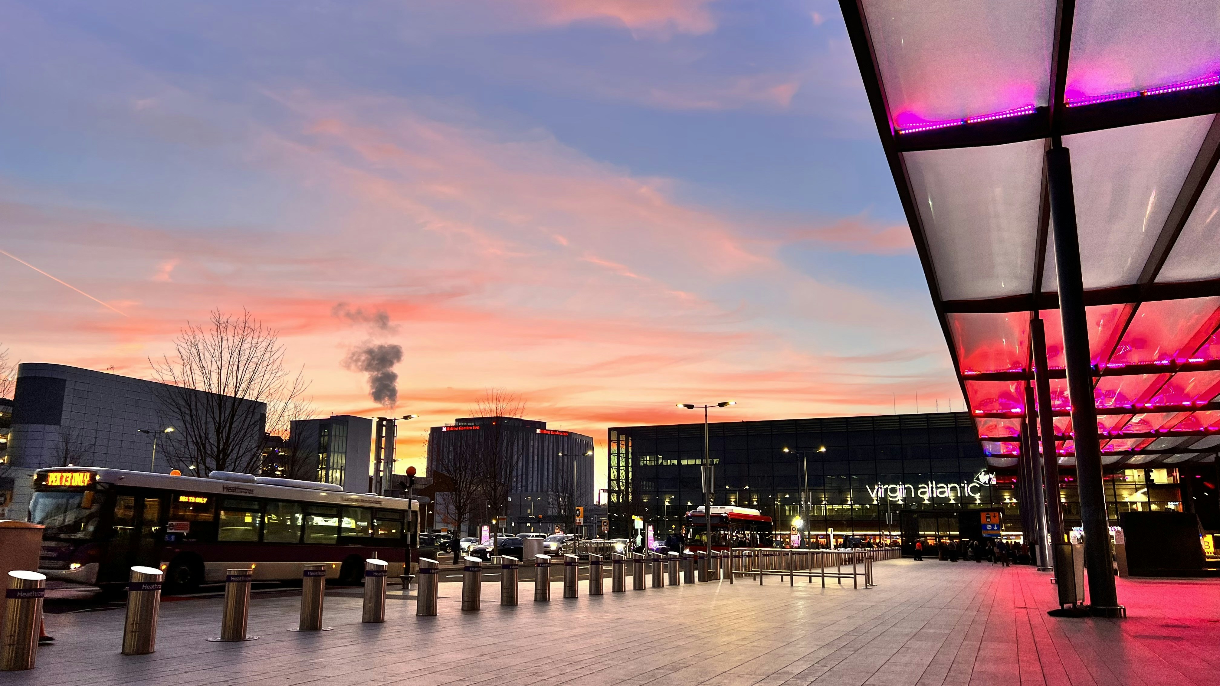 a city street with a bus parked on the side of it, 