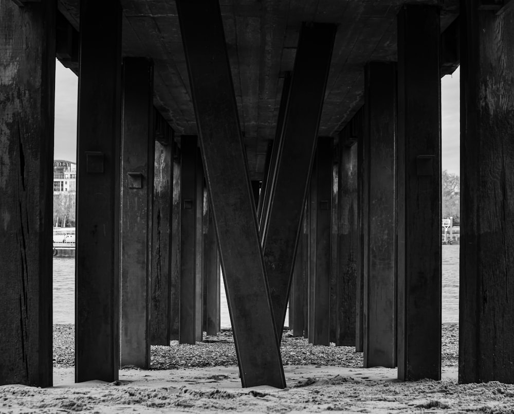 a black and white photo of the underside of a bridge