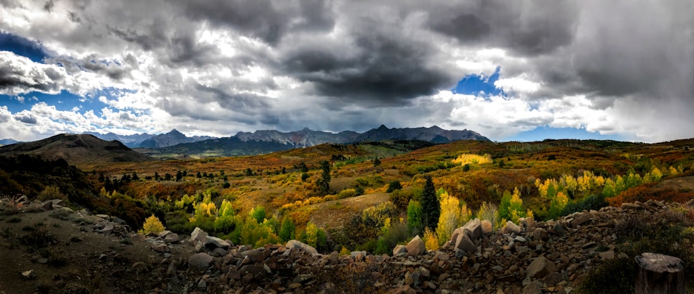 a scenic view of a mountain range under a cloudy sky