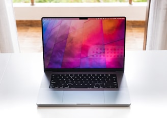 A stylish laptop open with a vibrant wallpaper on display.